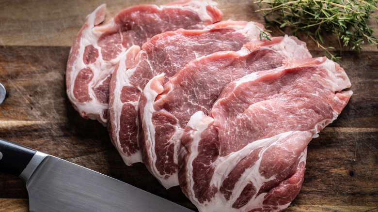 Chopped pieces of pork neck with thyme and herbs