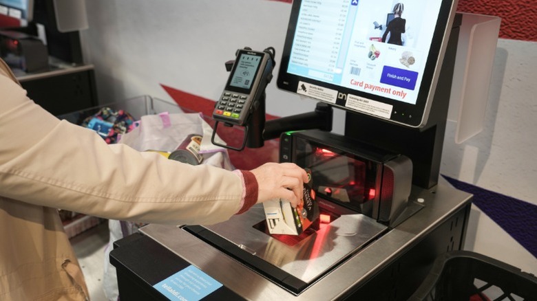 A customer using self-checkout at an Aldi.