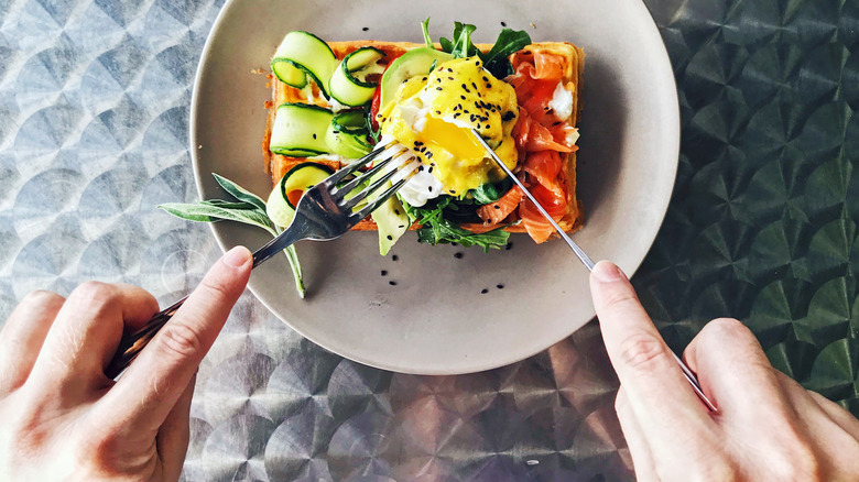 hands shown with utensils in European style