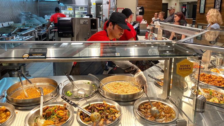 Worker at Panda Express serving food