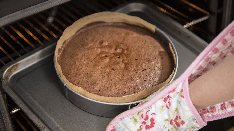 Taking a cake out of the oven