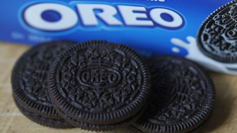 A close-up of Oreo cookies with packaging in background.