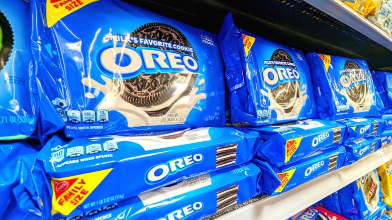 Packages of Oreo cookies on a supermarket shelf.