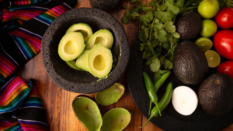 avocados in molcajete and guacamole ingredients