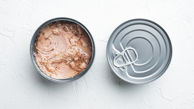 tuna in open can next to sealed can