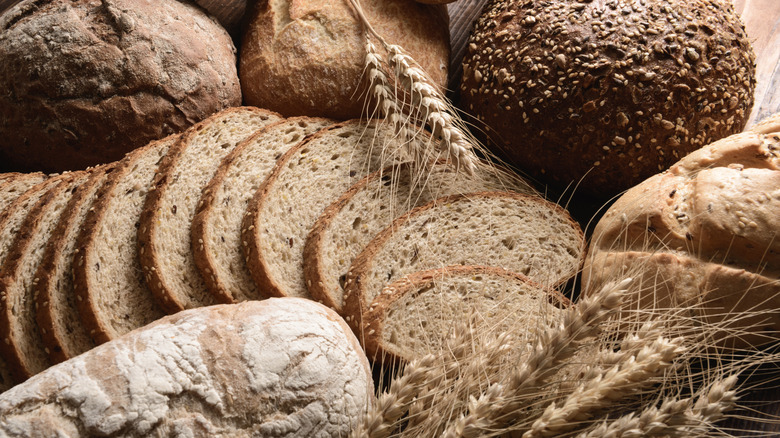Assorted whole and sliced loaves of bread