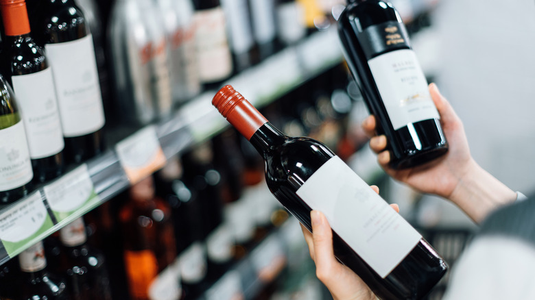 Woman looking at wine labels