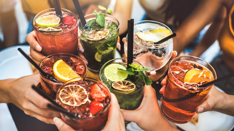A group of people toasting with their cocktails