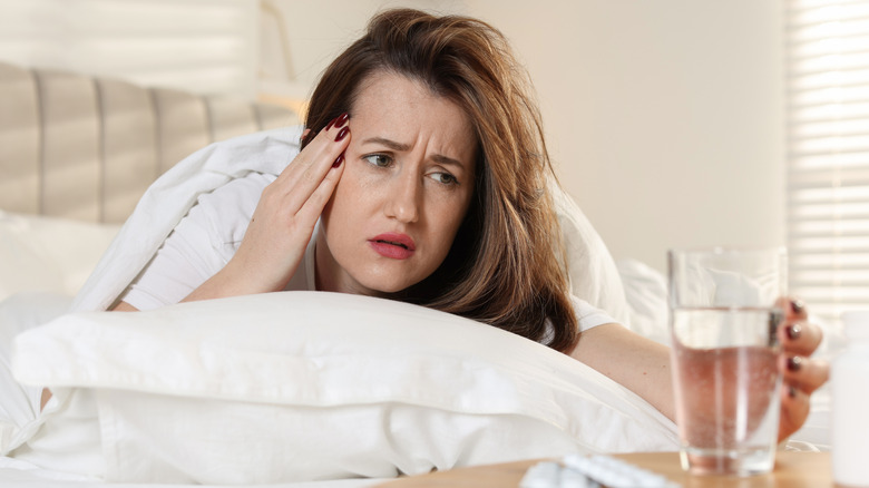 Unhappy woman suffering from a hangover