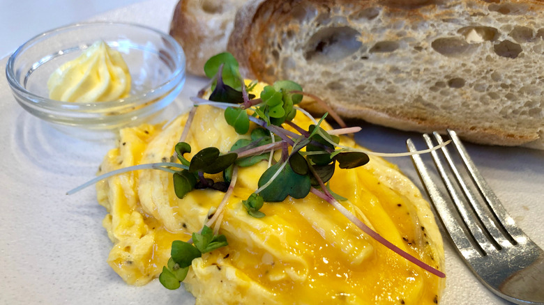 Silky scrambled eggs alongside toast