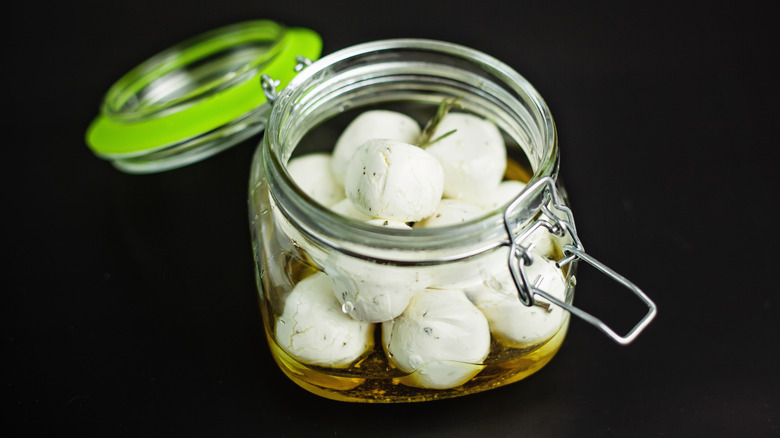 Cheese balls in jar of oil