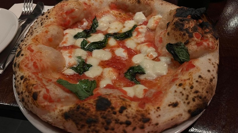 close-up of rustic Neapolitan pizza at Una Pizza Napoletana
