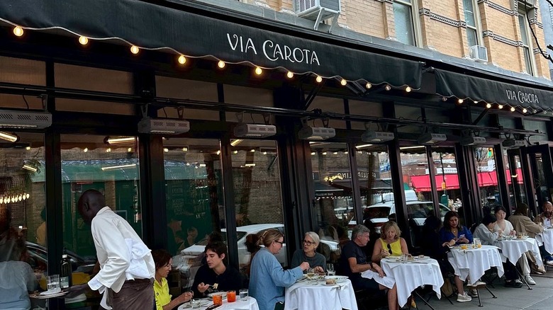 exterior of Via Carota with diners seated at outdoor tables