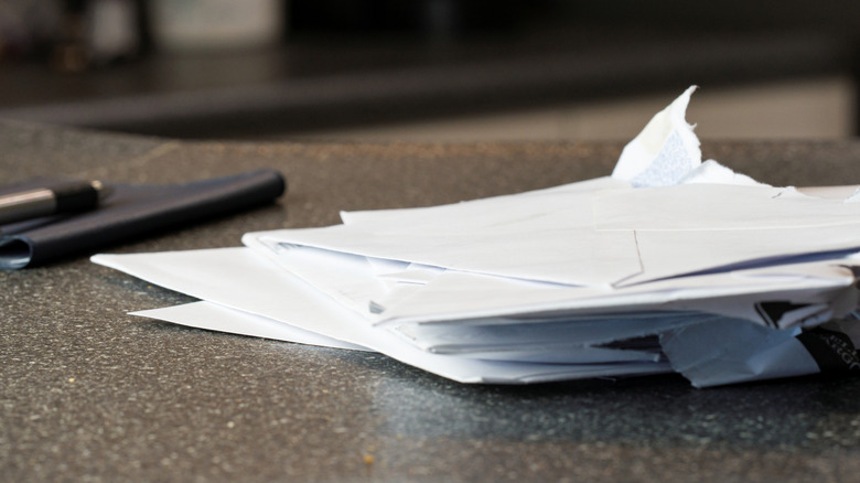 A stack of papers sitting on a countertop.