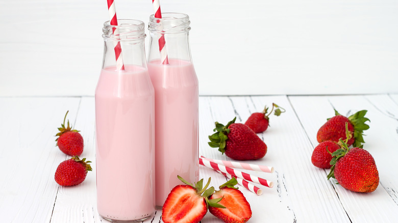 pink strawberry milk in glass bottles