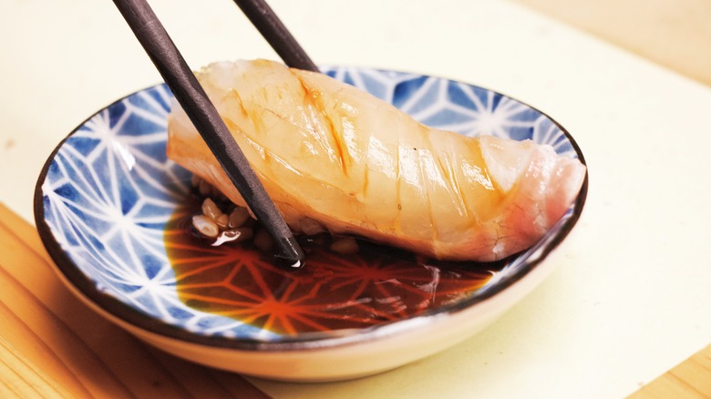sushi dipped in soy sauce