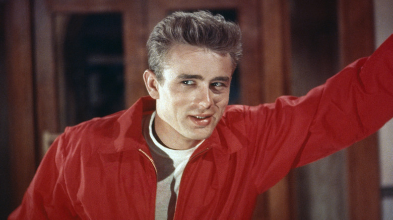 James Dean grinning in a red jacket