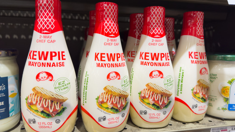 a grocery store shelf of Kewpie mayonnaise bottles