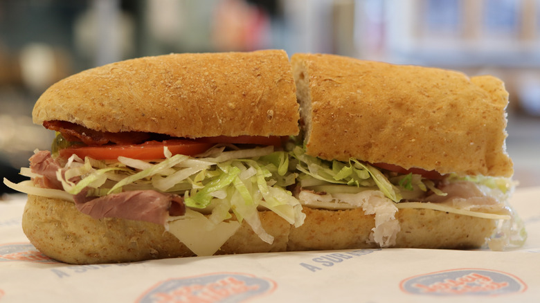 A Jersey Mike's sub sitting on wrapper paper with the logo