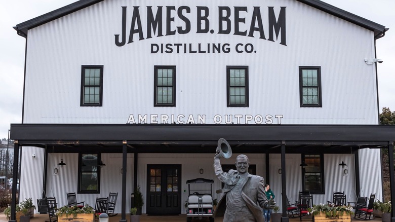 Jim Beam Distilling Company building in Clermont, Kentucky, with a statue of Jim Beam in front