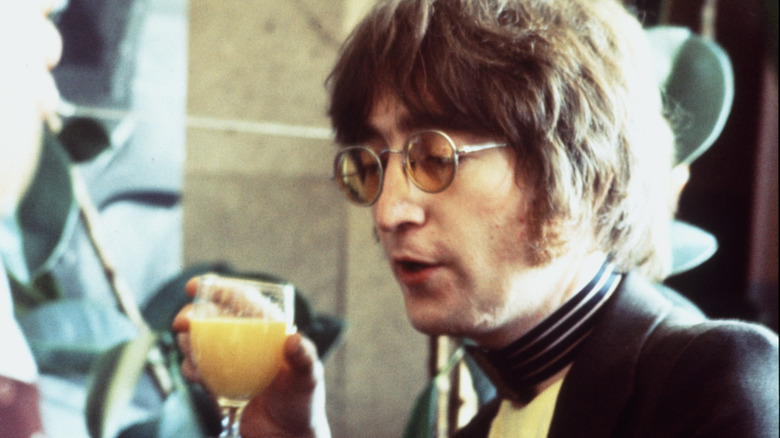John Lennon drinking orange juice at breakfast