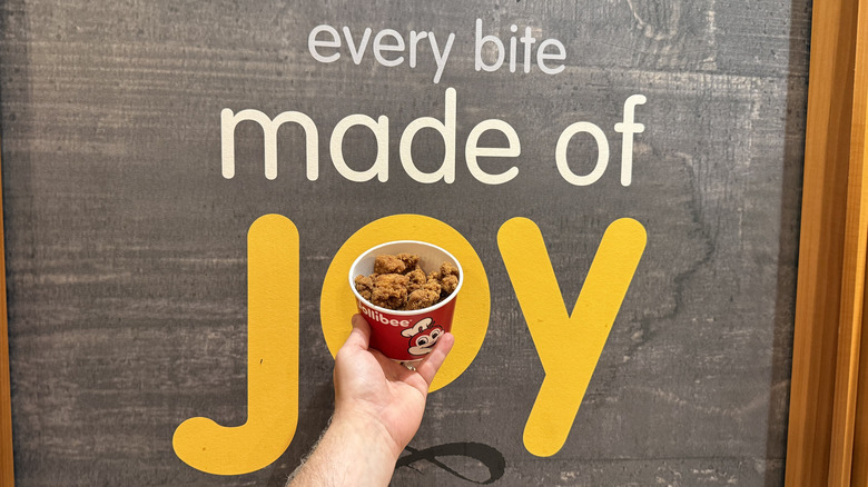 A bucket of nuggets makes an "o" in a sign that says "Joy"