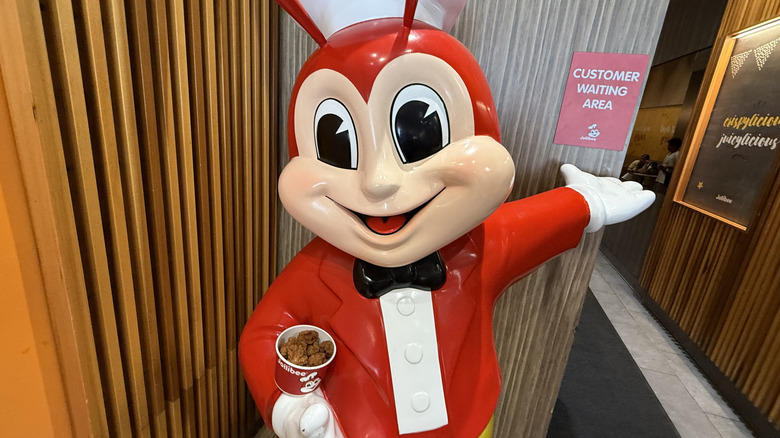 Jollibee mascot cradling chicken nuggets