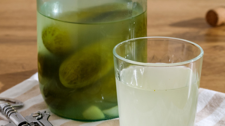 Pickle juice in jar and glass