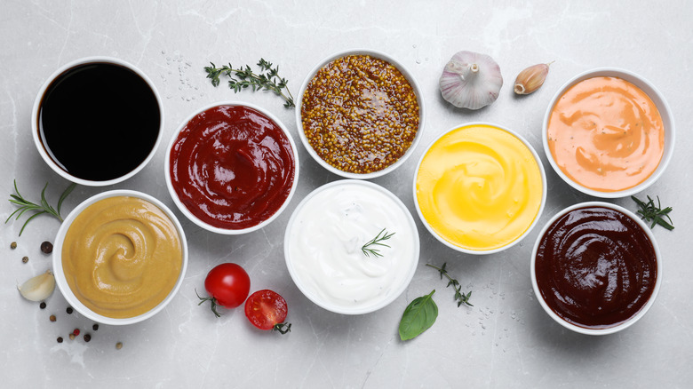 A spread of condiments in small white bowls