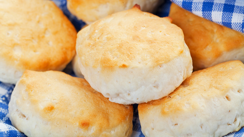 Flaky biscuits in a basket with blue gingham cloth