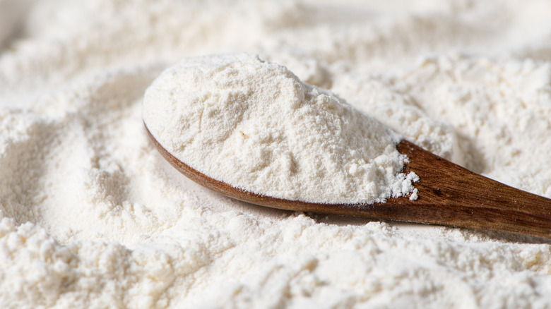 White wheat flour with a wooden spoon