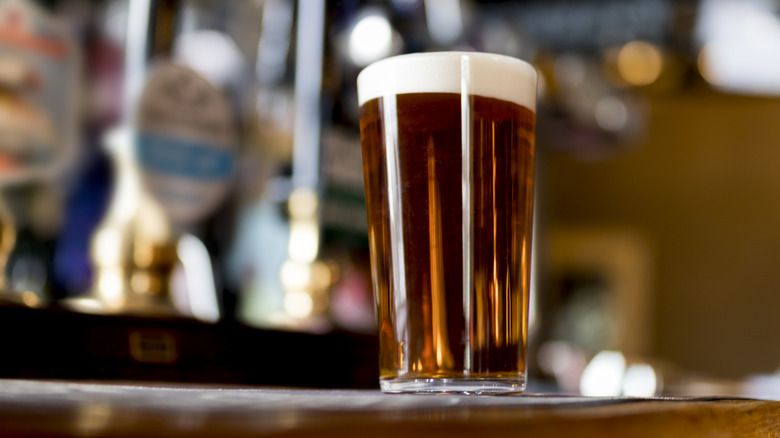 A pint of cask beer sitting on a bar