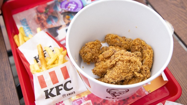 A view inside a KFC bucket with bone-in chicken inside.