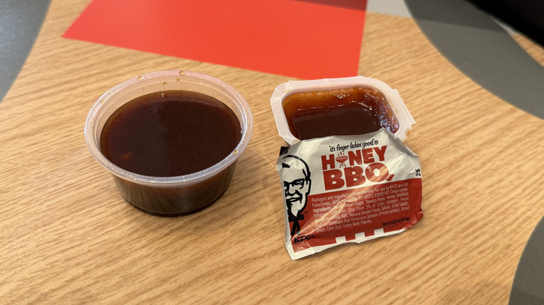 a cup of the Original Honey BBQ sauce stands next to the old current one