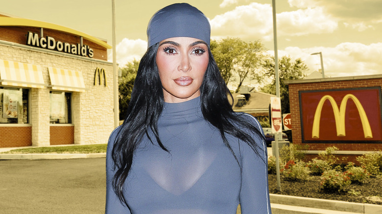 Kim Kardashian standing in front of a McDonald's restaurant