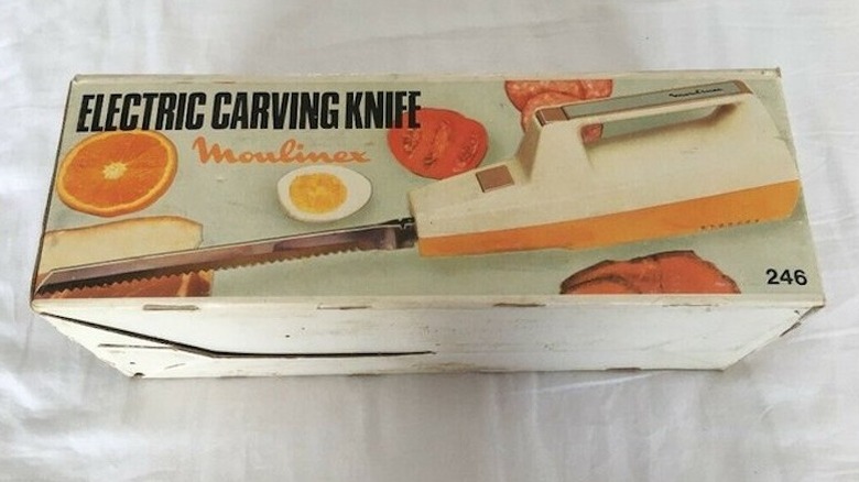 A vintage electric carving knife in a box