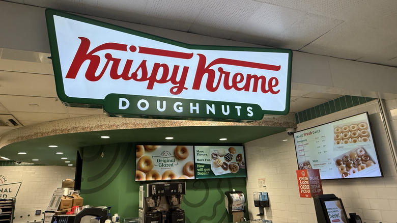 a Krispy Kreme Doughnuts sign with menu below