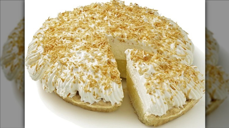 unwrapped Private Selection Coconut Crème Pie with one slice slightly separated from the rest of the pie