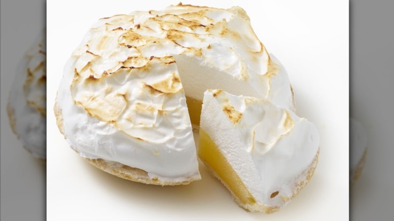 unwrapped Bakery Fresh Lemon Meringue Pie with one slice slightly separated from the rest of the pie