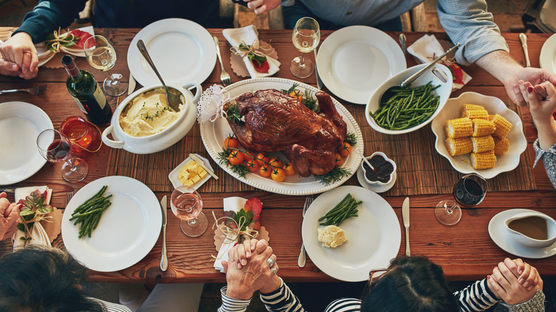 A family gathered around a Thanksgiving table.