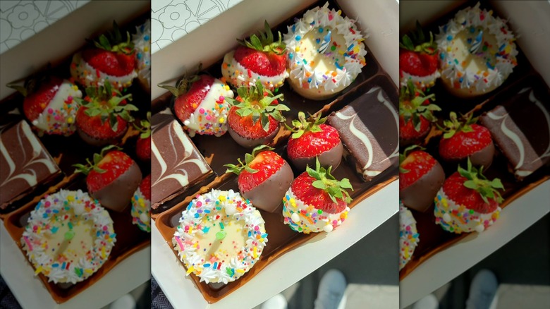 Edible Arrangements gift box with chocolate-covered strawberries, mini cakes, and brownies