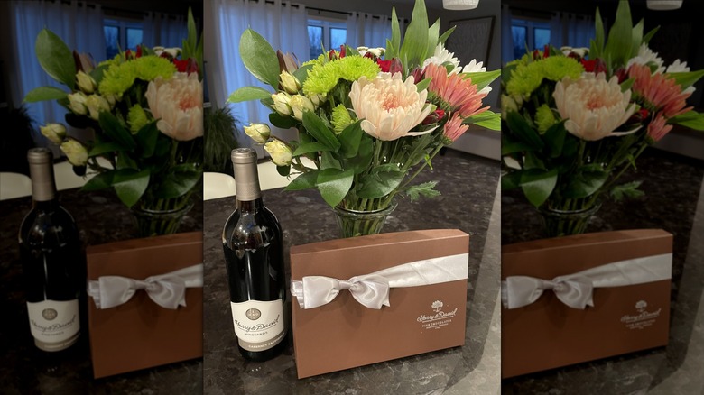 Harry and David gift of wine, chocolate, and flower bouquet on kitchen counter