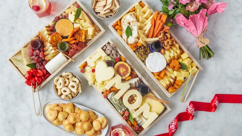 Murray's Cheese Mother's Day cheese boards with cheeses, veggies, nuts, snacks, and fresh flowers