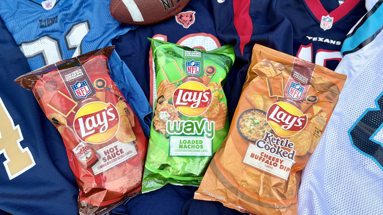 Bags of Lay's limited edition NFL potato chips on a background of football jerseys