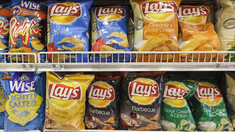 Various flavors of Lay's potato chips on store shelf