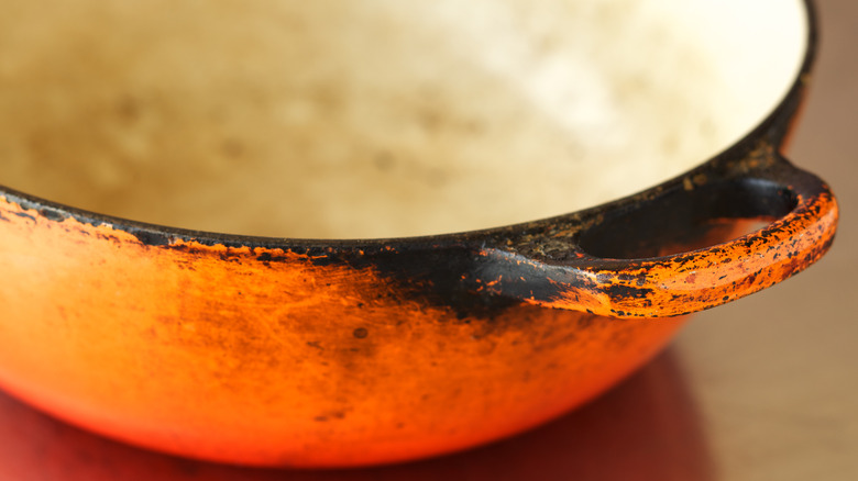 Damaged orange cast iron enamel pan