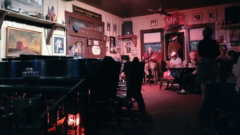 A band playing in an old railway depot turned dive bar