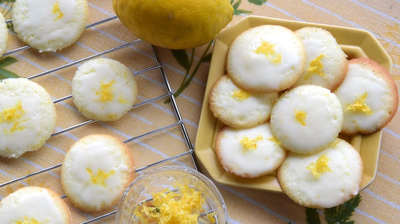 Iced lemon cookies on a yellow tablecloth outside