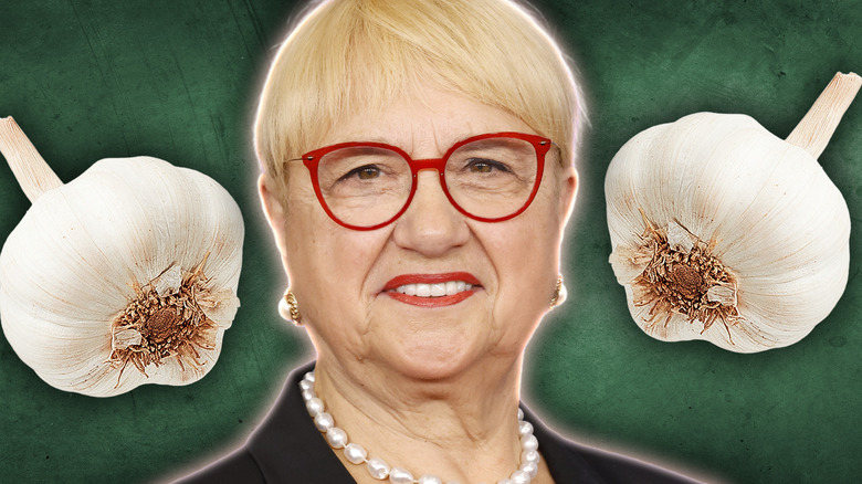 Lidia Bastianich smiling with bulbs of garlic floating around her head.