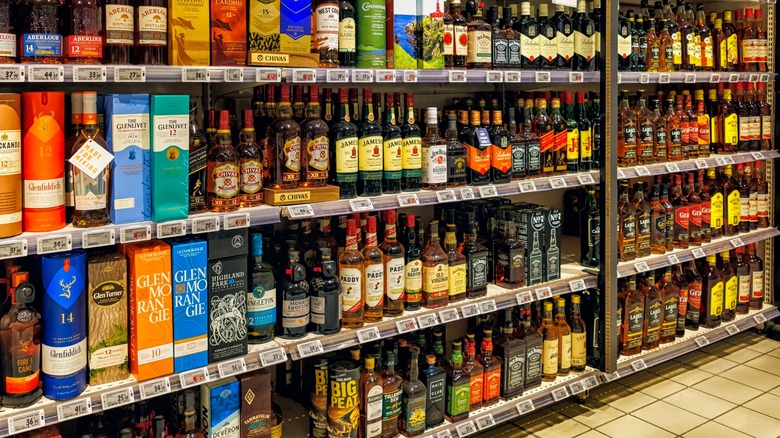 Bottles of liquor on shelves on liquor store